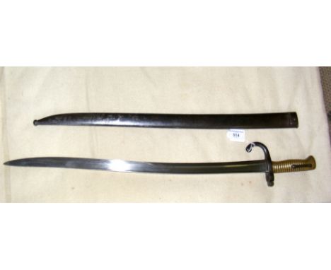 A large French sword bayonet with metal scabbard and inscription to the blade