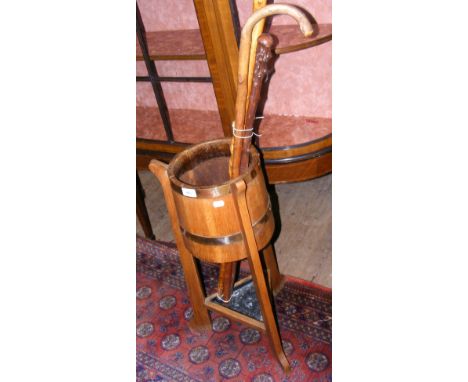 An oak and metal bound stick stand, together with wooden walking sticks
