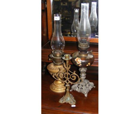 Victorian oil lamp and one other, together with a candlestick