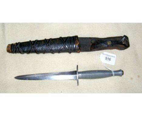 An old Commando dagger in leather scabbard
