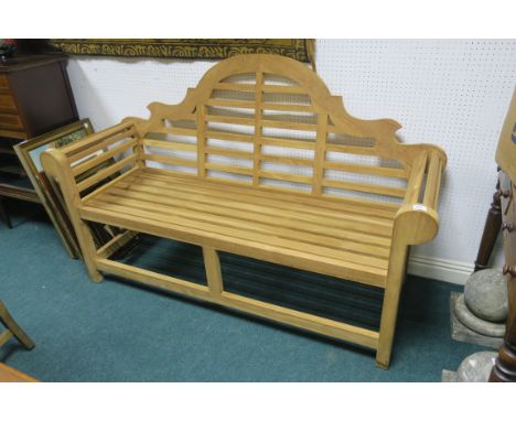 A HARDWOOD GARDEN BENCH, the rectangular arched slat back and seat with scroll arms and moulded legs,164cms wide.