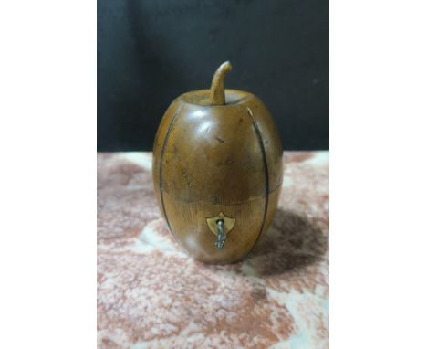 A TURNED WOOD TEA CADDY, in the form of a pineapple, the hinged top lifting to reveal a silvered interior with shield shaped 