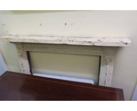 A CAST IRON FIRE SURROUND, the rectangular shelf raised on moulded uprights with scroll decoration,106cms x 100cms x 15cms.