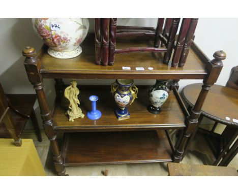 A VICTORIAN MAHOGANY THREE TIER DUMB WAITER each moulded shelf joined by baluster support on brass castors 106cm X 90cm X 40c