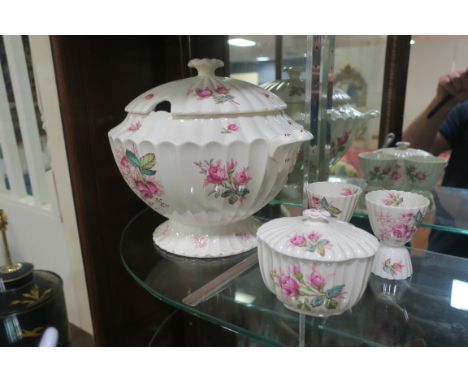 A GLAZED PORCELAIN SOUP TUREEN, by Copeland Spode, of circular moulded outline the white ground decorated with pink foliate s