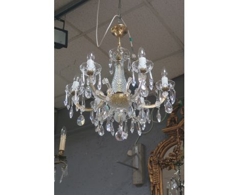 A PAIR OF SIX LIGHT CUT GLASS CHANDELIERS, the diamond cut glass support issuing scrolled arms hung with pendant drops with f