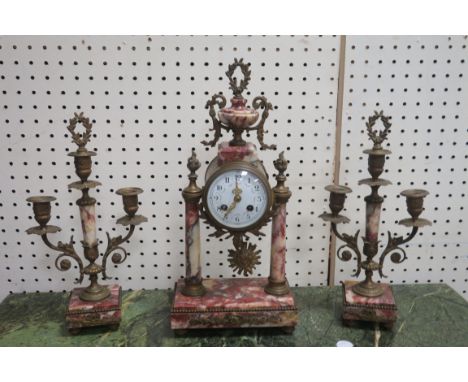 A CONTINENTAL MARBLE AND GILT BRASS MOUNTED CLOCK GARNITURE in classical style the clock with white enamel dial the brass han