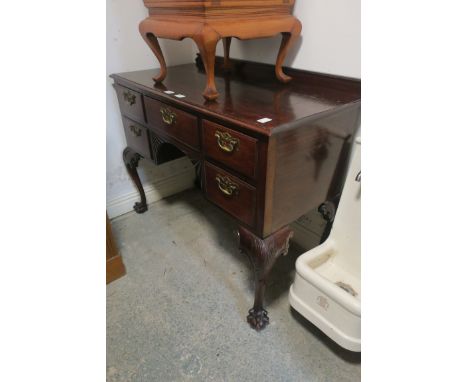 A CHIPPENDALE STYLE MAHOGANY DESK rectangular top above one long and two short drawers with brass drop handle on cabriole leg