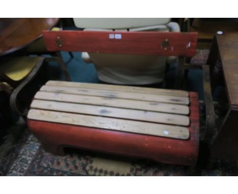 A METAL AND PINE GARDEN SEAT, modelled as a tractor bonnet with scroll arms, 129cms wide.