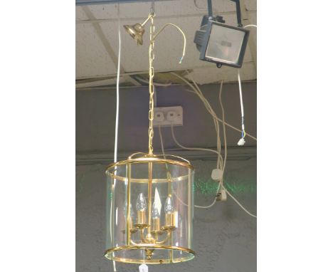 A BRASS AND GLASS FOUR LIGHT HALL LANTERN, of cylindrical outline.