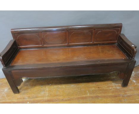 AN ORIENTAL STYLE CARVED WOOD BENCH, the rectangular panelled back with shaped  sides panelled seat above a shaped apron on s