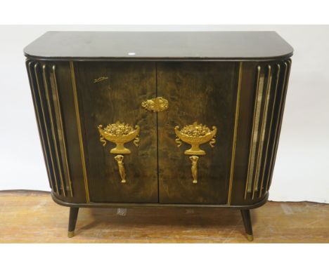 A 20TH CENTURY WALNUT FRAMED RADIOGRAM by KUBA the rectangular top above a pair of panel doors applied with classical and gil