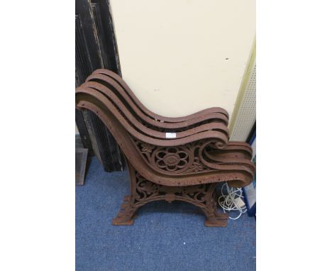 FOUR CAST IRON BENCH ENDS, each with scroll arms and pierced sides on splayed legs.