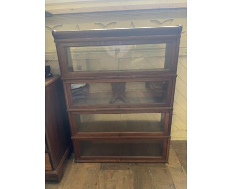 A Globe Wernicke style oak four section bookcase, lacking backs, 87 cm wide, an oak drop leaf table, a nest of tables, and an