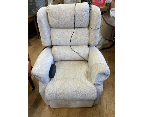 A cream upholstered reclining chair, with an electric motor, a tile top nest of tables, a pair of modern chests of drawers an