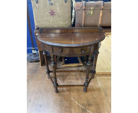 An oak demi-lune side table, 84 cm wide, a trunk, 90 cm wide, a drop leaf table, a Windsor chair, a standard lamp, a trunk, a