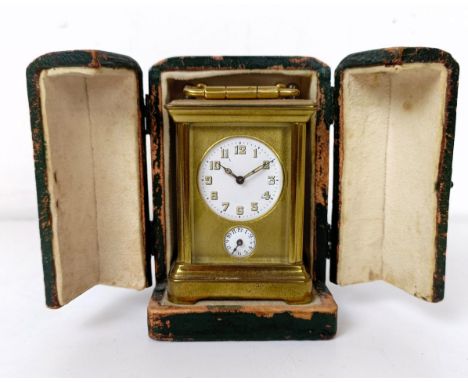 A miniature carriage clock, with alarm, the enamel dial,  with Arabic numerals, in a brass and glass case, 11 cm high, cased 