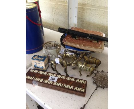 A cribbage board together with a filigree silver metal spoon, brass animals and other items.