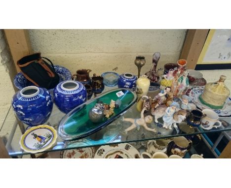 A shelf containing a large quantity of various china and glass items.