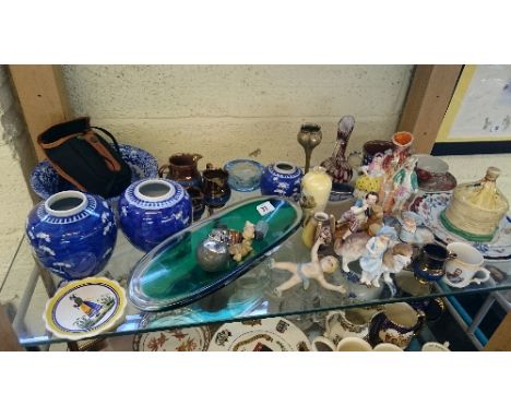 A shelf containing a large quantity of various china and glass items.