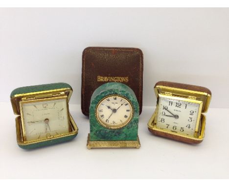 A small Swiza green marble cased mantle clock with brass mounts together with two travelling alarm clocks and a Bravingtons p