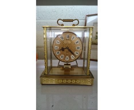 A brass and glass cased Kundo electro-magnetic ATO mantle clock by Kieninger & Obergfell.