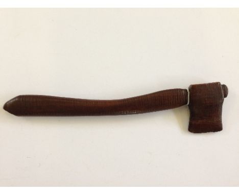 A small ceremonial Maori axe made from black beech wood. 