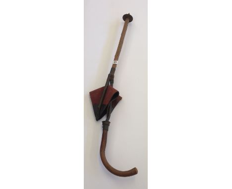 An early 20th century shooting stick with folding leather seat.