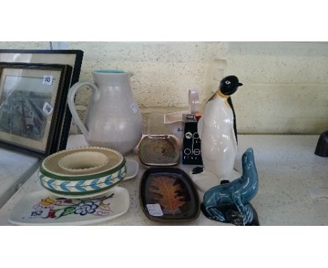 A collection of various Poole Pottery items including a penguin, basket and a Honiton posy ring.