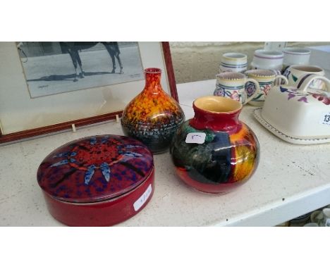 Three various modern Poole Pottery Studio items including two vases and a circular box and lid.