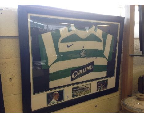 A framed Celtic football club green and white stripped football shirt signed by Henrik Larsson.