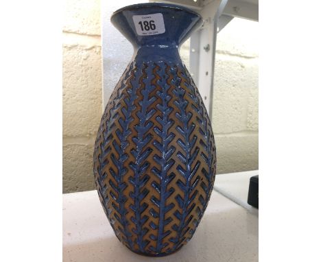 A modern Poole Pottery Atlantis Revival carved vase by Alan White with blue glaze.