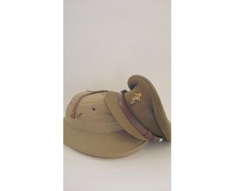 A near mint Wolseley sun helmet, Army & navy stores together with WWII officers cap.