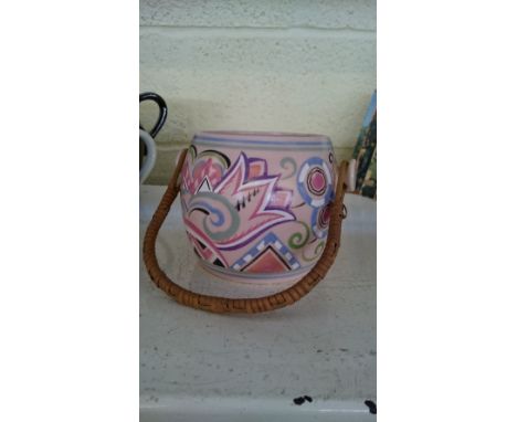 A Poole Pottery biscuit barrel, shape 230 decorated in the JE pattern with wicker handle (no lid).
