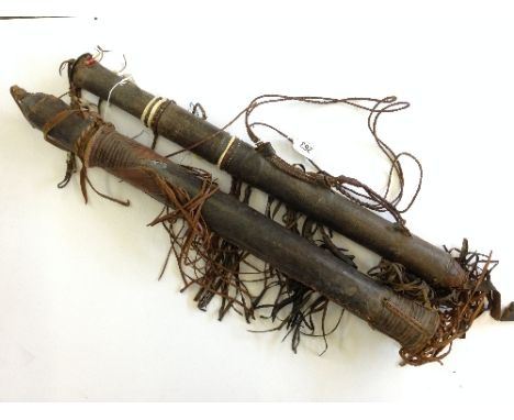 Two ethnic arrow quivers together with a small quantity of arrows.