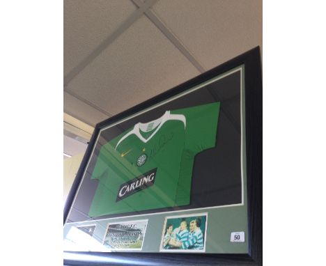 A framed Celtic green football shirt signed by Henrik Larsson.