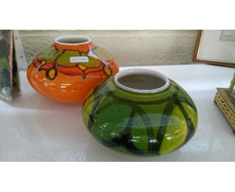 A Poole Pottery Delphis squat vase, shape 32, decorated in an abstract pattern on orange ground together with another.