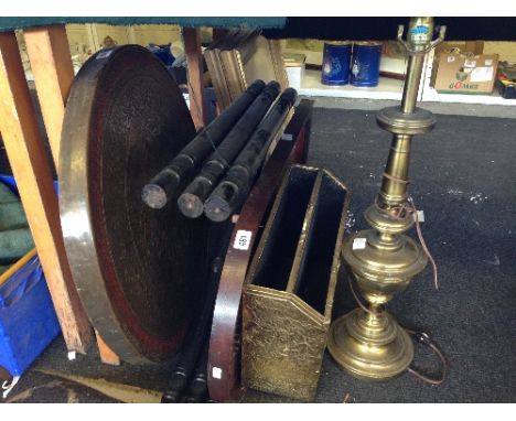 A small brass topped Eastern circular table together with a magazine rack, brass lamp and a wooden bagatelle board.