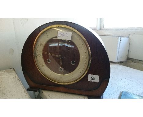 An early 20th century Art Deco oak cased chiming mantle clock.