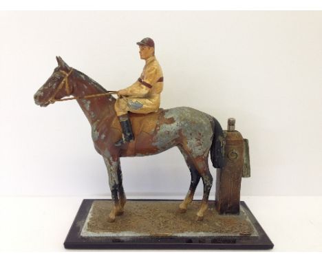 An early 20th century cold painted Spelter cigarette lighter modelled as a horse and jockey with integral striker attached to