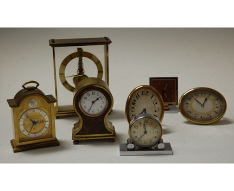 An early 20th century burr walnut and brass cased alarm clock, of balloon shape, having an enamelled dial with Arabic numeral