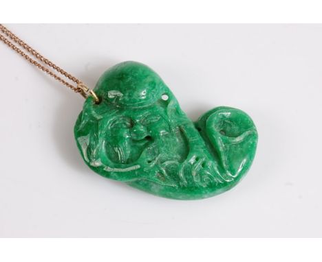 A carved jade (probably treated) figure of Shou Lou, 52mm wide, with chain and clasp stamped '9k', cased