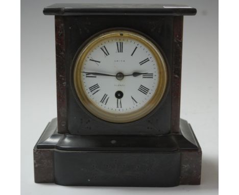A late Victorian black slate and rouge marble mantel clock, of typical form, having enamelled dial with Roman numerals and si