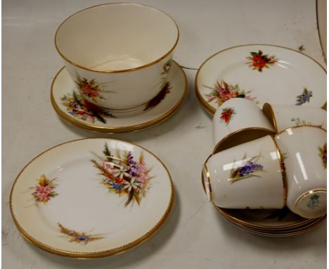 A circa 1900 Royal Worcester part tea service on white ground painted with various floral sprays, heightened in gilt having p