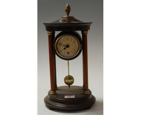 An early 20th century bakelite portico type clock, having enamelled dial with Arabic numerals, surmounted by an acorn finial,