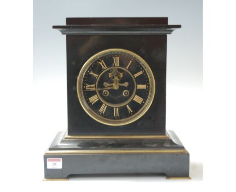 A large late 19th century black slate and brass cased mantel clock, the chapter ring with gilt Roman numerals, having visible