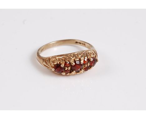 A 9ct garnet ring, with scrolled gallery and plain band stamped 375, size K, (2.4g)