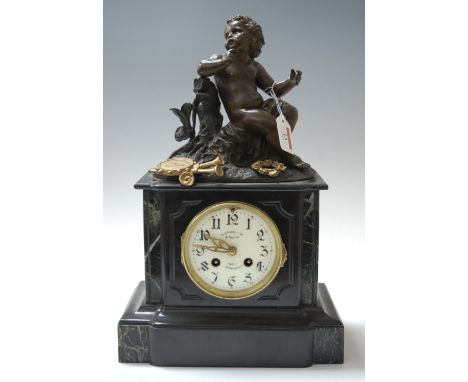 A late 19th century black slate and marble cased mantel clock, of typical form, surmounted with a bronzed cherub musician, th