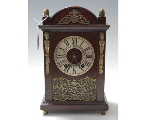 An early 20th century mahogany cased mantel clock, having a silvered dial with Roman numerals, and an eight day movement stri