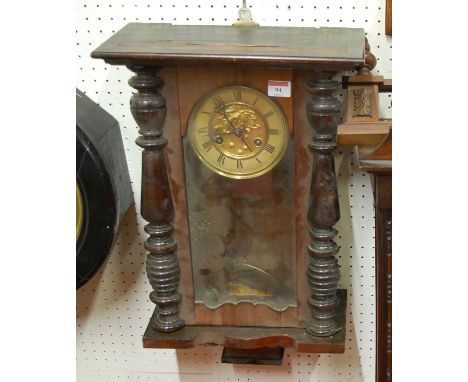 An early 20th century oak cased wall clock having enamel dial, Roman numerals, and eight day movement together with one other